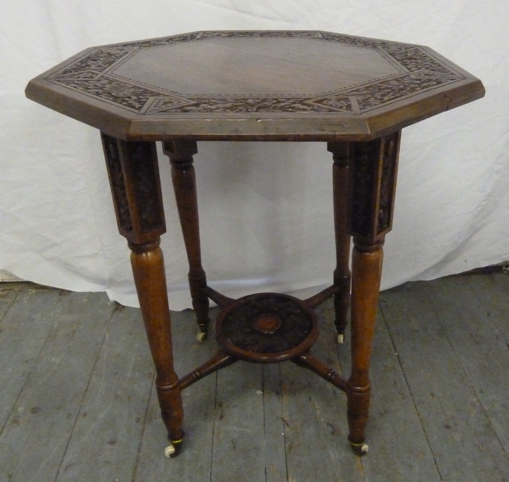 An Arts and Crafts octagonal oak side table on four tapering cylindrical legs