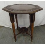 An Arts and Crafts octagonal oak side table on four tapering cylindrical legs