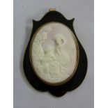Cameo brooch set in black enamel and gold frame tested 9ct