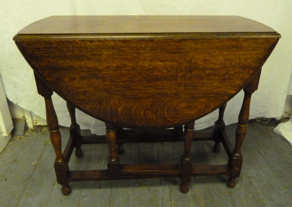 An oak gate leg drop flap table of customary form