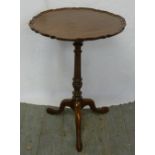 Mahogany wine table with pie crust border on three outswept legs