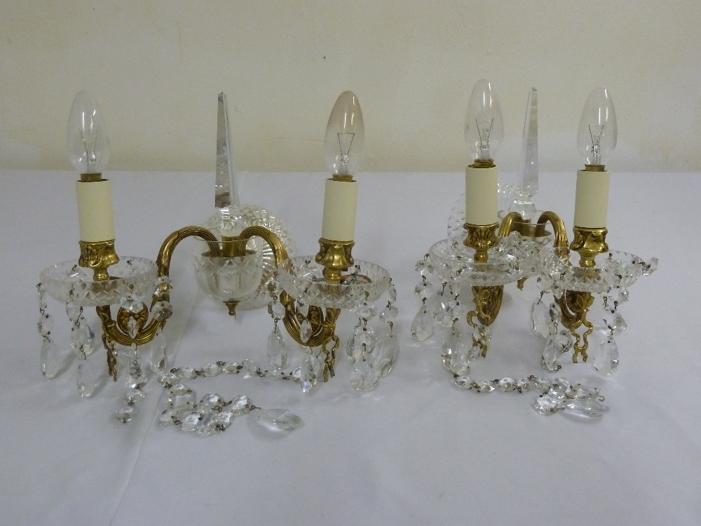 A pair of crystal and gilt metal wall lights