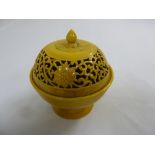 A 19th century Chinese yellow ground porcelain incense burner with pierced pull off cover