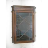 Edwardian mahogany and satinwood inlaid wall hanging cabinet, with astral glazed door