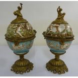 A pair of French 19th century urns gilt and Majolica with figural terminals