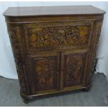 An Oriental hardwood cocktail cabinet profusely carved with hinged cover and sides