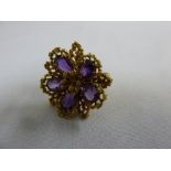 A 1970s 18ct gold and amethyst floral shaped ring, approx total 10.8g