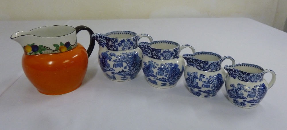 Four T.G. Green blue and white Ming jugs willow pattern circa 1912 and a T.G. Green orange Dutch