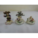 A Derby figurine and two putti figurines with gold anchor marks, A/F