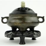 A bronze censer
on 3 feet with 6 character mark, diameter 4.5" with carved wood cover and jade knop