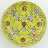 A yellow ground shallow dish
with peach blossom and bat decoration, with 6 character mark, 5.75".