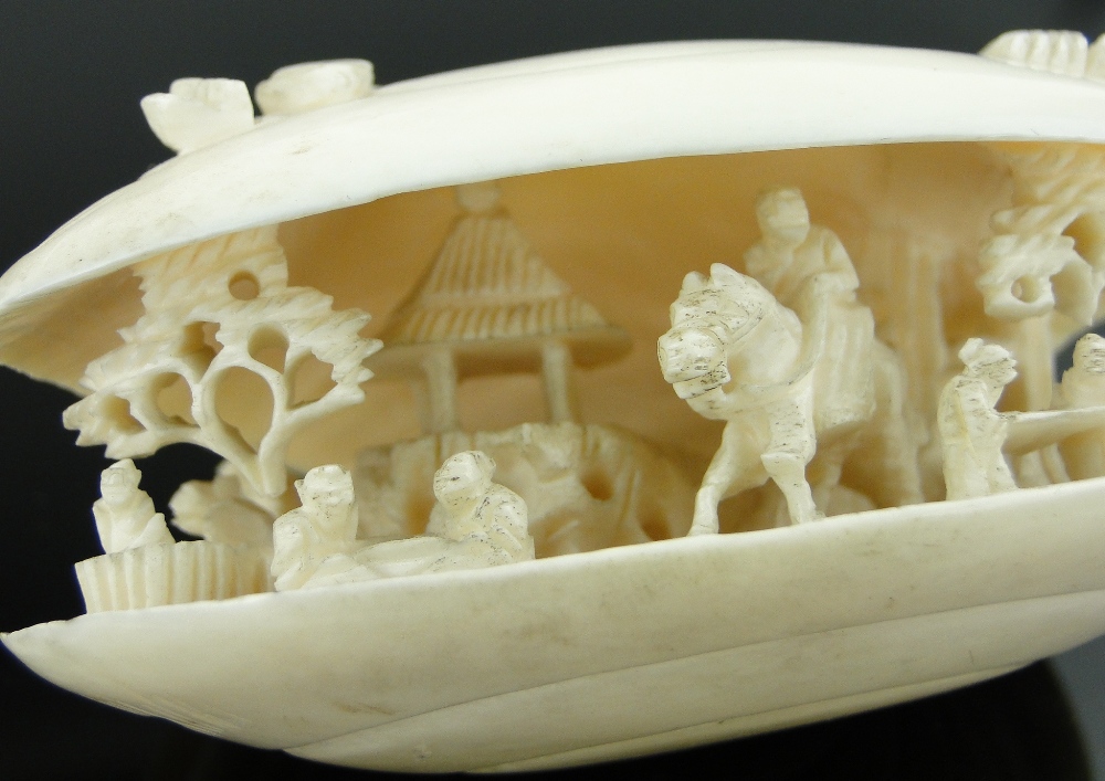 A Chinese carved ivory shell
containing figures and a horseman, length 2.75". - Image 10 of 10