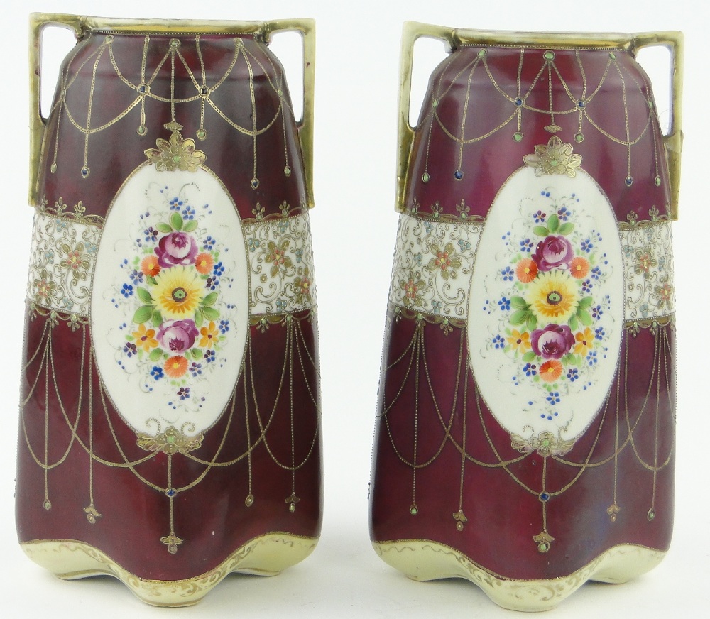 A pair of Japanese 2-handled porcelain vases
with painted floral panels, 12.25".