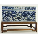 A blue and white Chinese box
with dragon design, length 8.75", on fitted wooden stand.