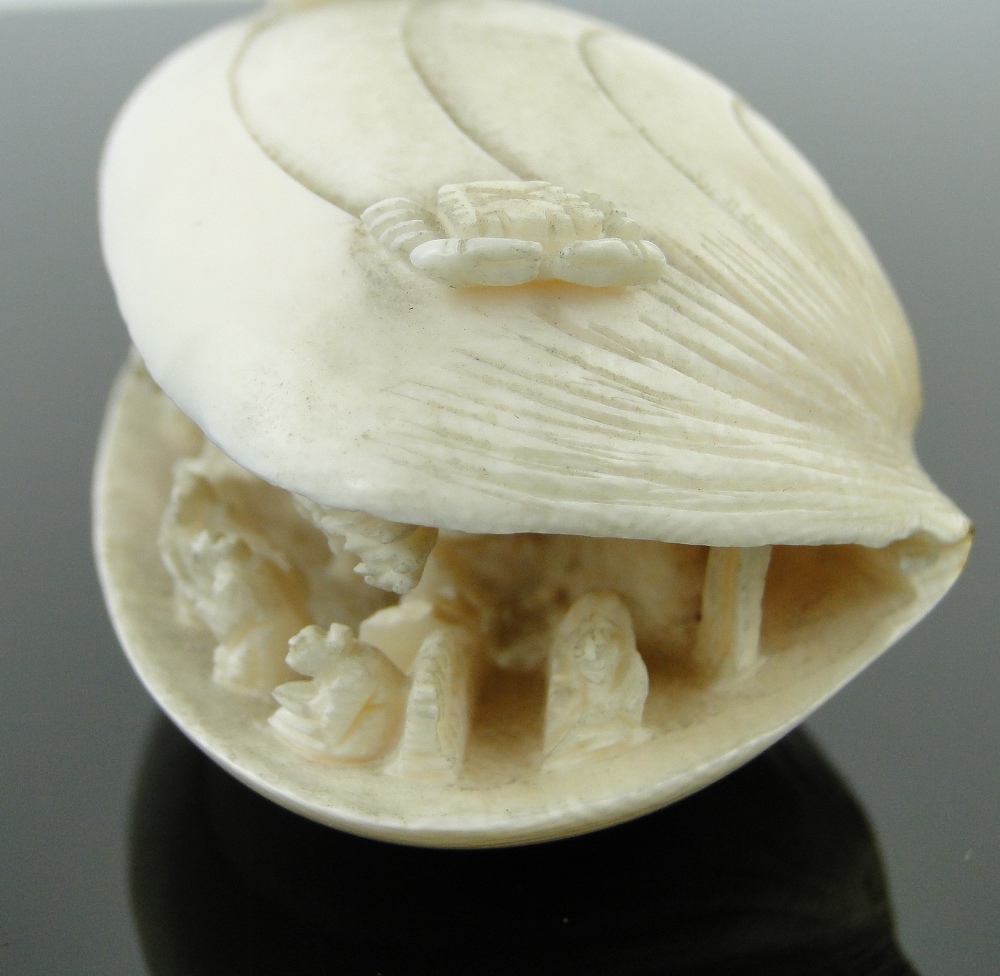 A Chinese carved ivory shell
containing figures and a horseman, length 2.75". - Image 5 of 10