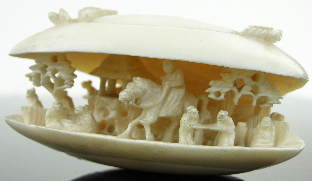 A Chinese carved ivory shell
containing figures and a horseman, length 2.75". - Image 3 of 10