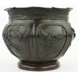 A 19th century bronze jardiniere
with raised applied bird and bamboo motifs, height 9.5".