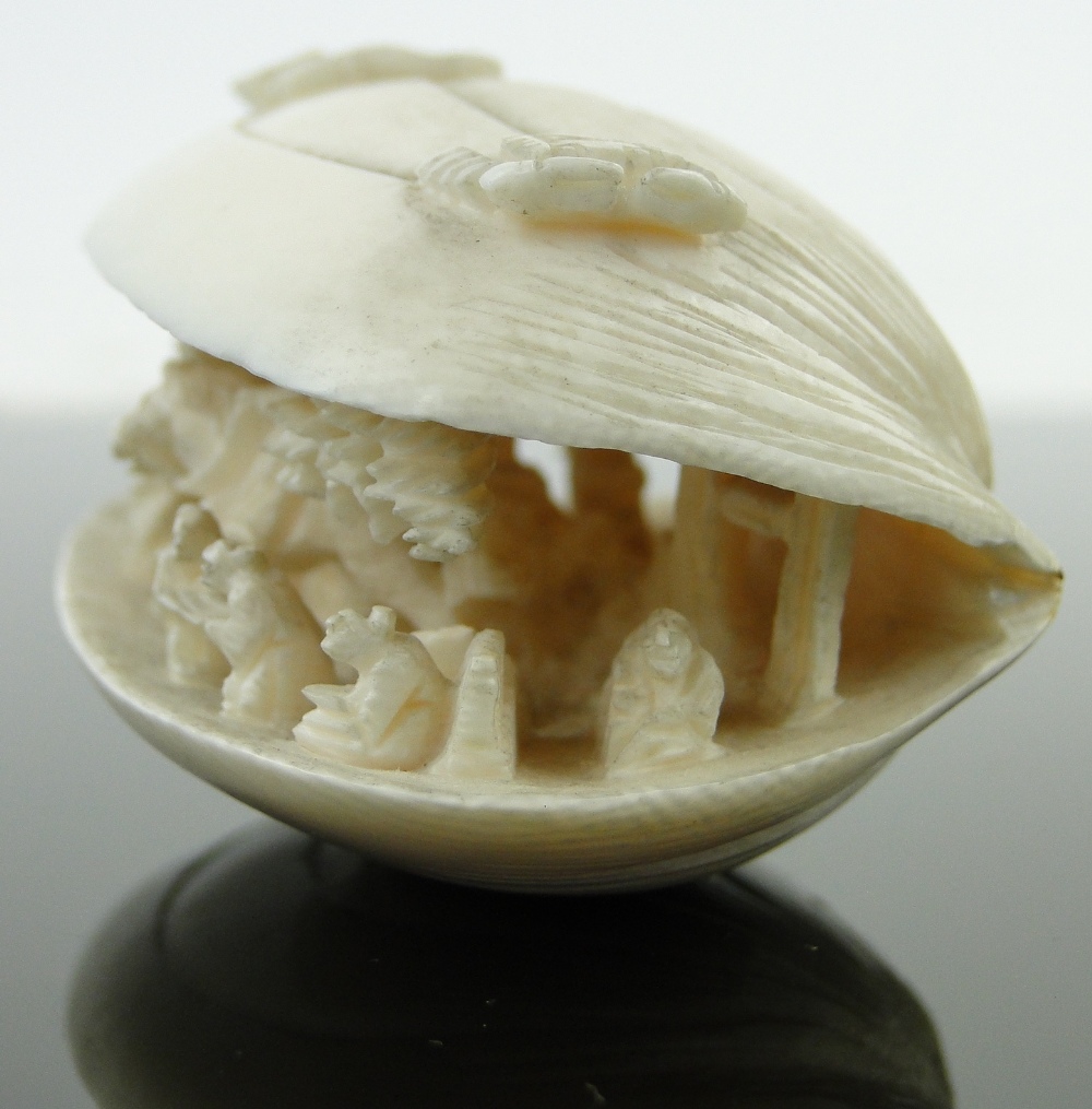 A Chinese carved ivory shell
containing figures and a horseman, length 2.75". - Image 8 of 10