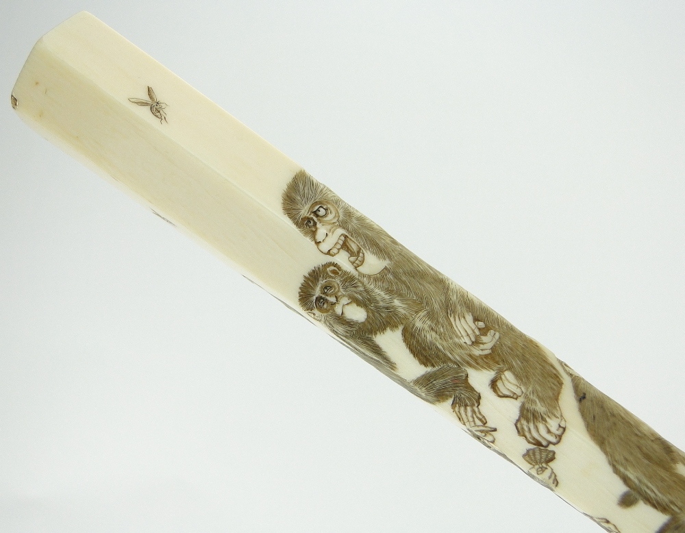 A Chinese umbrella with carved ivory handle
depicting a family of monkeys. - Image 2 of 2