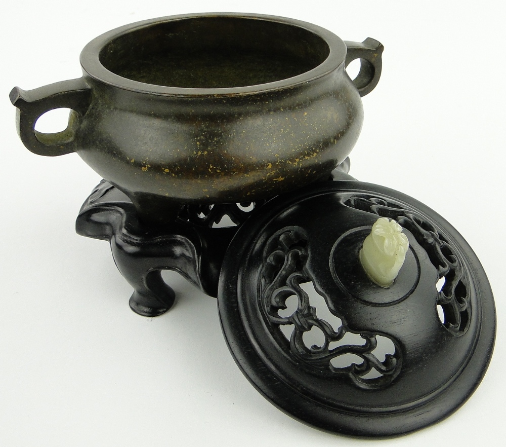 A bronze censer
on 3 feet with 6 character mark, diameter 4.5" with carved wood cover and jade knop - Image 5 of 8