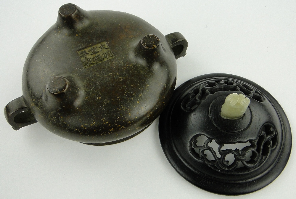 A bronze censer
on 3 feet with 6 character mark, diameter 4.5" with carved wood cover and jade knop - Image 7 of 8