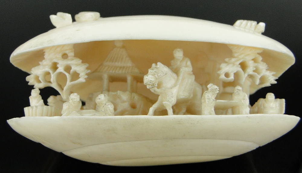 A Chinese carved ivory shell
containing figures and a horseman, length 2.75". - Image 9 of 10