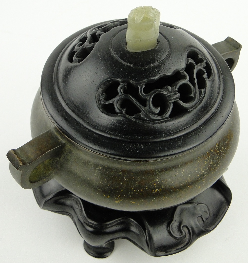 A bronze censer
on 3 feet with 6 character mark, diameter 4.5" with carved wood cover and jade knop - Image 4 of 8