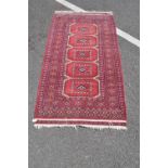 A red ground Afghan rug.