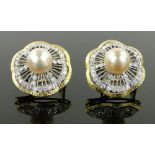 Pair of large 18ct pearl and diamond set circular earrings,
diamond content approx. 2.
