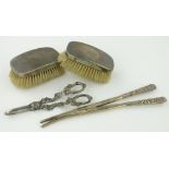 Box containing silver mounted glove stretchers,
silver backed brushes, grape scissors, etc.