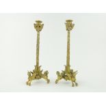 A pair of ormolu candlesticks
with owl figures, ivy decorated stems and tripod supports, 12.75".