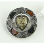 A Scottish circular silver brooch
with central heart shaped citrine, 28mm across.
