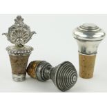 An ornate Victorian silver bottle stopper and 2 others, (3).