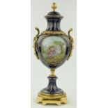 An ornate continental porcelain urn
with gilded decoration and gilt metal mounts, height 21.5".