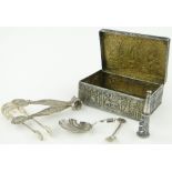 A box containing Continental white metal box,
Egyptian revival silver tongs, etc.
