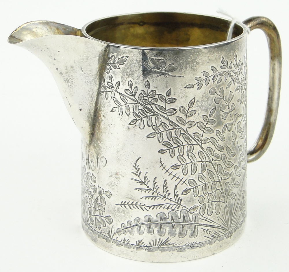 A Victorian engraved silver cream jug,
London 1880.