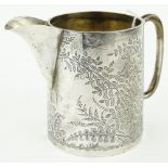 A Victorian engraved silver cream jug,
London 1880.