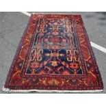 A red ground wool Persian rug,
6'6" x 4'4".
