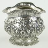 A Continental silver pot
with raised floral swags import marks London 1893, length 7cm.