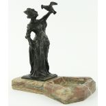 A bronze figure of a lady with a hawk
mounted on a marble dish, height 9" overall.