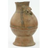A pre-Columbian pot 
with painted figurative head handle, height 14.5".