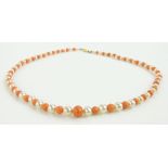 A graduated coral and pearl necklace with 9ct clasp.