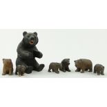 A Black Forest carved wood bear,
height 3.5" and 6 small Black Forest bears, (7).
