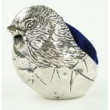 A miniature silver chick design pin cushion,
Chester 1918, length 25mm.
