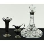 A cut-glass ships decanter with silver collar,
a George III silver cream jug and a silver posy vase,