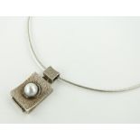 A 1970s pendant set with a 6.5mm split pearl,
indistinct mark possibly Fendi.