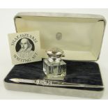 A silver mounted glass inkwell and dip pen, cased.