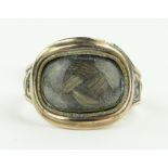 A 19th century memorial ring with hair panel.