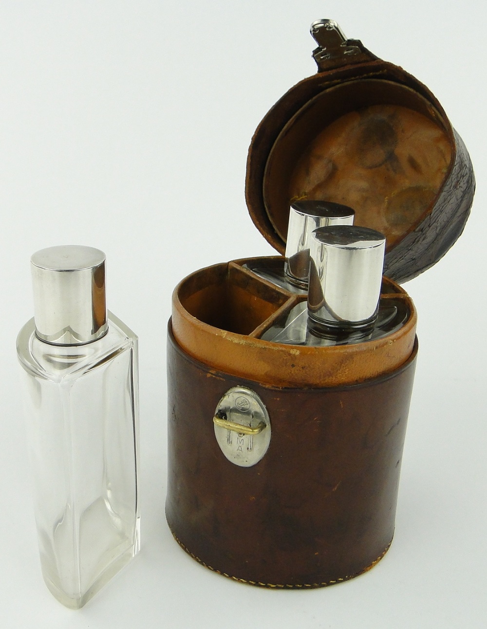 A nesting set of 3 cut-glass spirit bottles with silver tops,
circa 1940s,