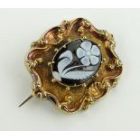 A Victorian unmarked yellow metal brooch
set with hardstone Cameo floral panel, height 30mm.